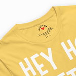 Yellow t-shirt with white text and a brand logo on a white background