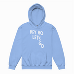 Light blue hoodie with 'HEY HO LET'S GO' text on a white background