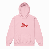 A light pink pullover hoodie with a red 'NOT SORRY' graphic printed on the chest, displayed against a clean white background.