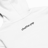 Close-up of a white hoodie showing the back with the text 'chatter pop' printed in black lowercase letters.