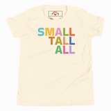 Beige t-shirt with colorful 'SMALL TALL ALL' text and a brand logo on a white background